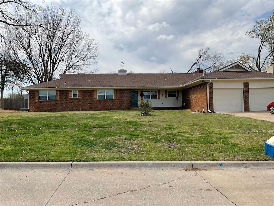Ranch-style house with a garage and a front lawn