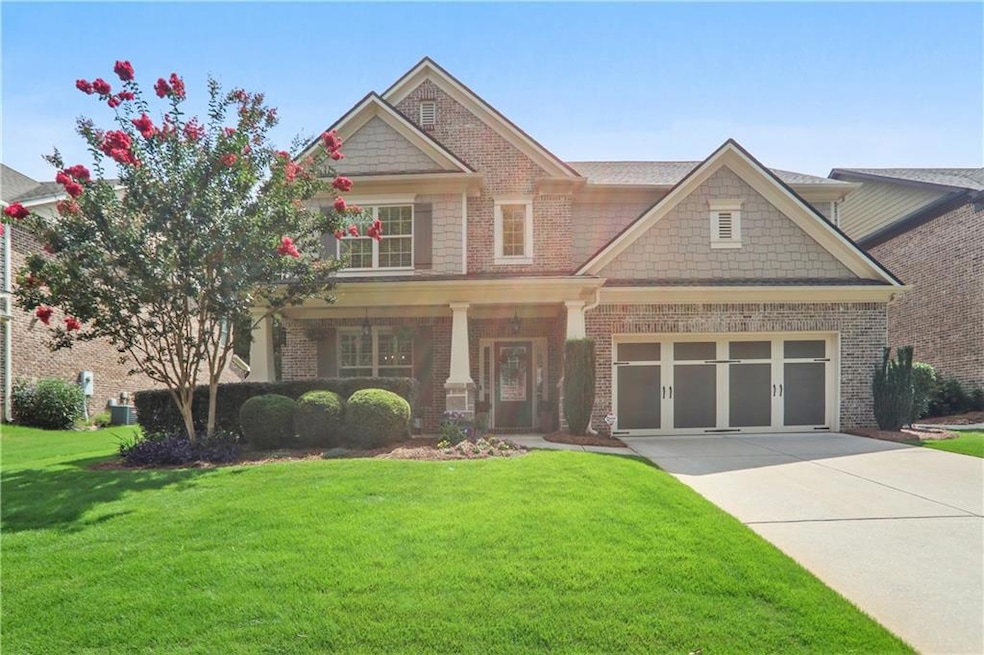 Craftsman-style house featuring cooling unit, a ga