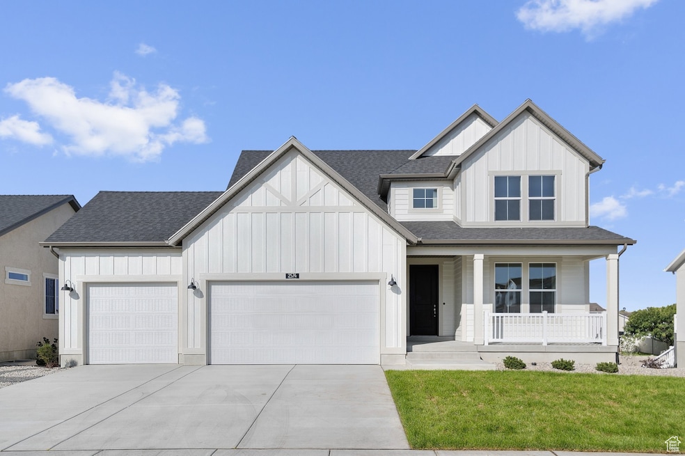 Modern farmhouse featuring board and batten siding, covered porch, a shingled roof, and a front yard