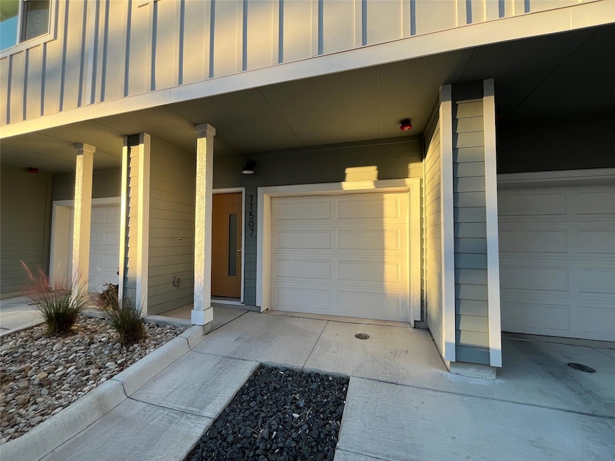 View of exterior entry featuring a porch and a garage