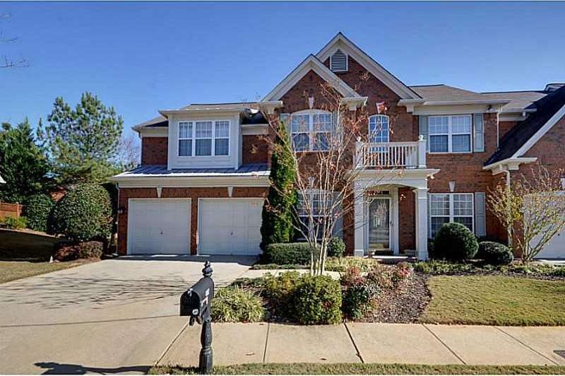 Exterior Front. Four sided brick end unit with 2 c