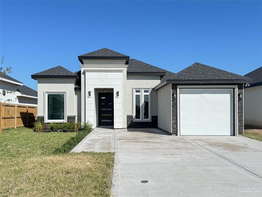 Prairie-style house with a garage and a front yard