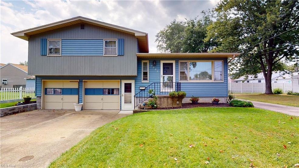 Split level home with a front lawn