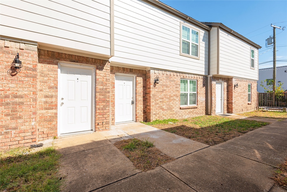 Entrance to property featuring brick siding