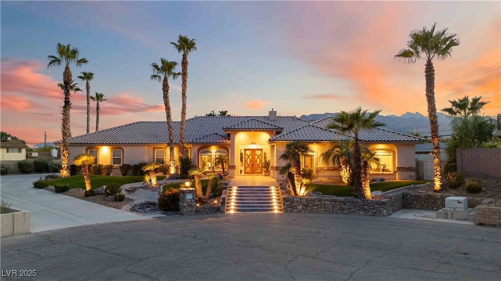 Mediterranean / spanish house featuring a chimney, stucco siding, and a tiled roof