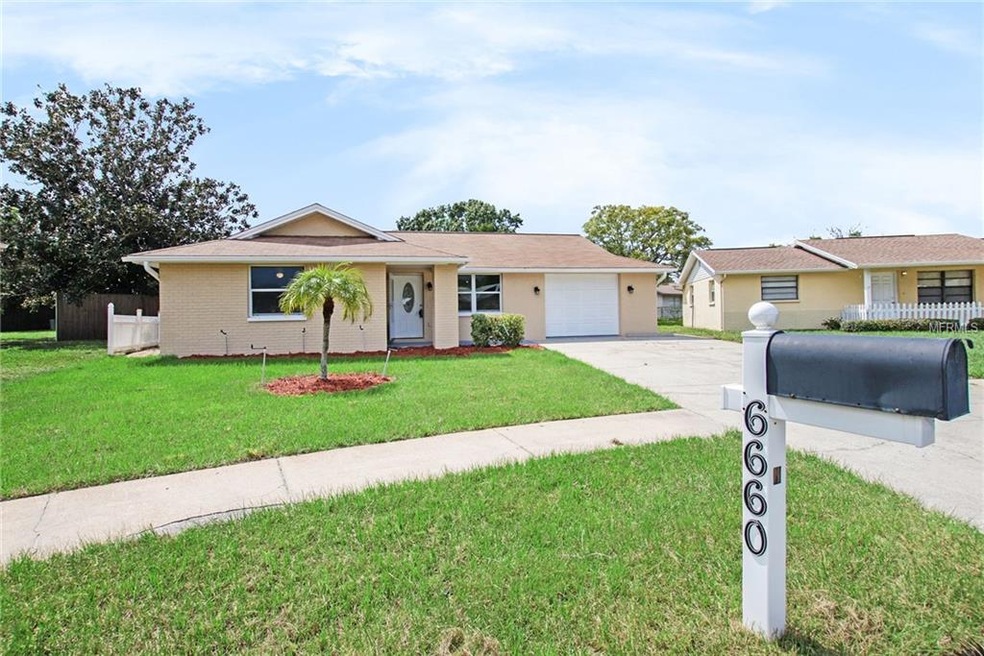 Exterior of the home, fresh sod and red fine mulch