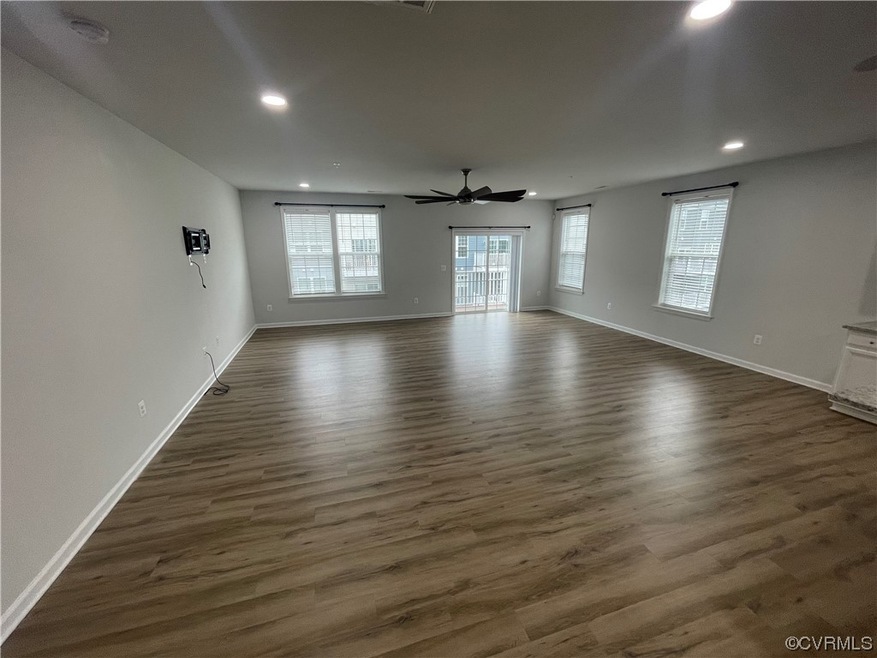 Hardwood floored spare room with ceiling fan