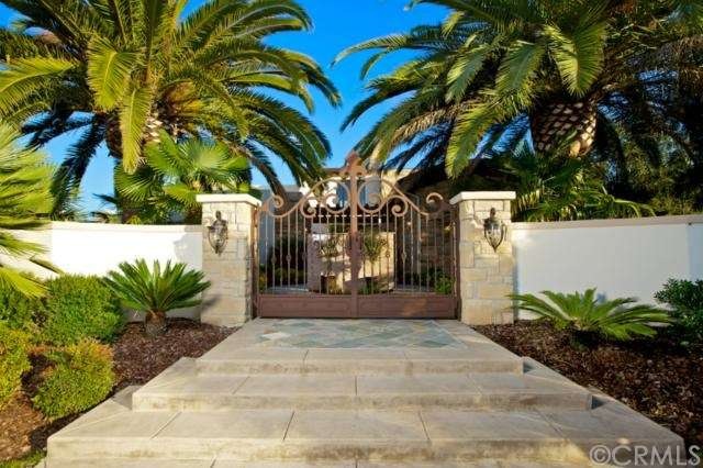 Impressive wrought iron gates provide a dramatic e