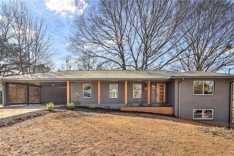 View of front of house featuring a carport and cov