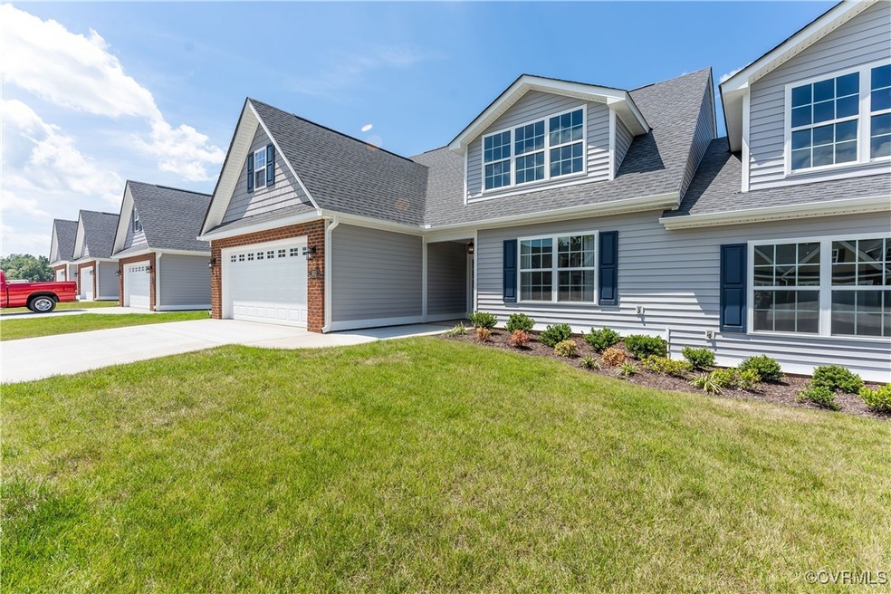 View of front of home with a front lawn and a gara