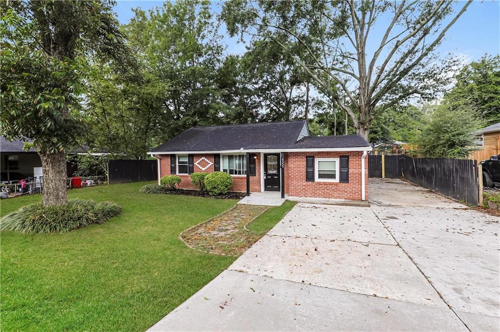 Single story home featuring brick siding, driveway, and a shingled roof