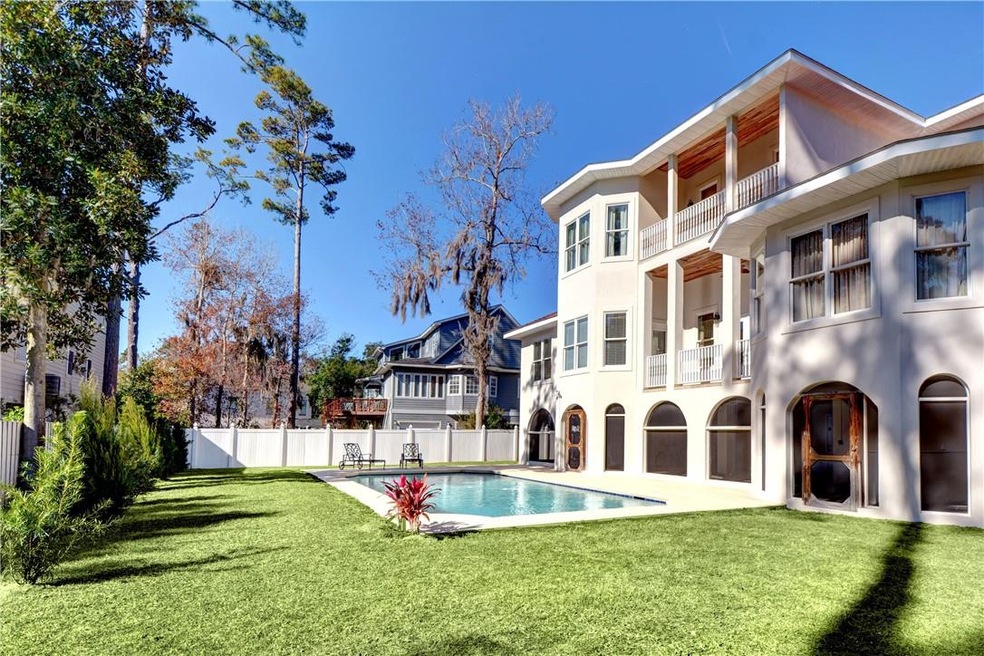Pool area with rear view of home