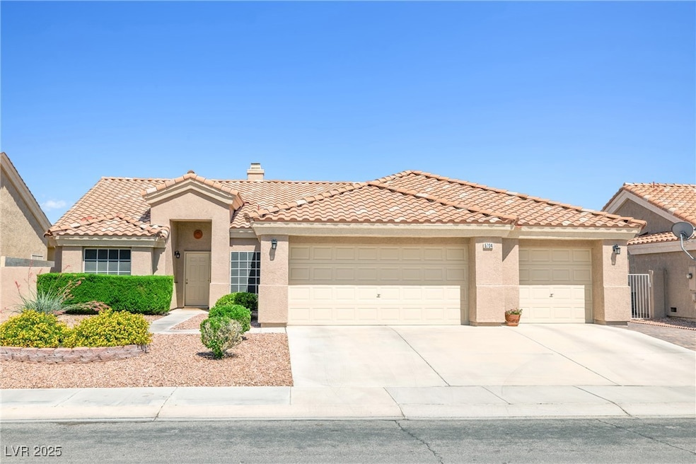 View of front facade featuring stucco siding, a ga