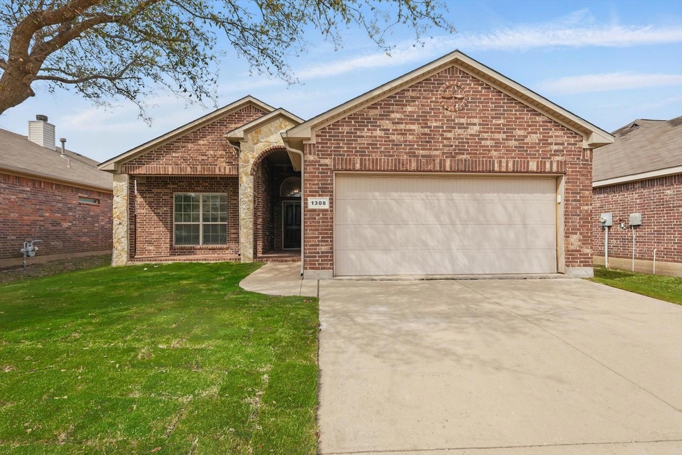 Ranch-style home featuring driveway, brick siding,