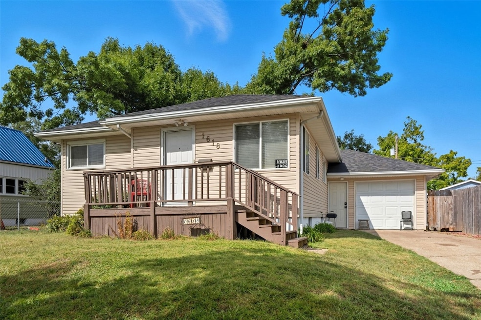 Front of home with small wooden deck 
