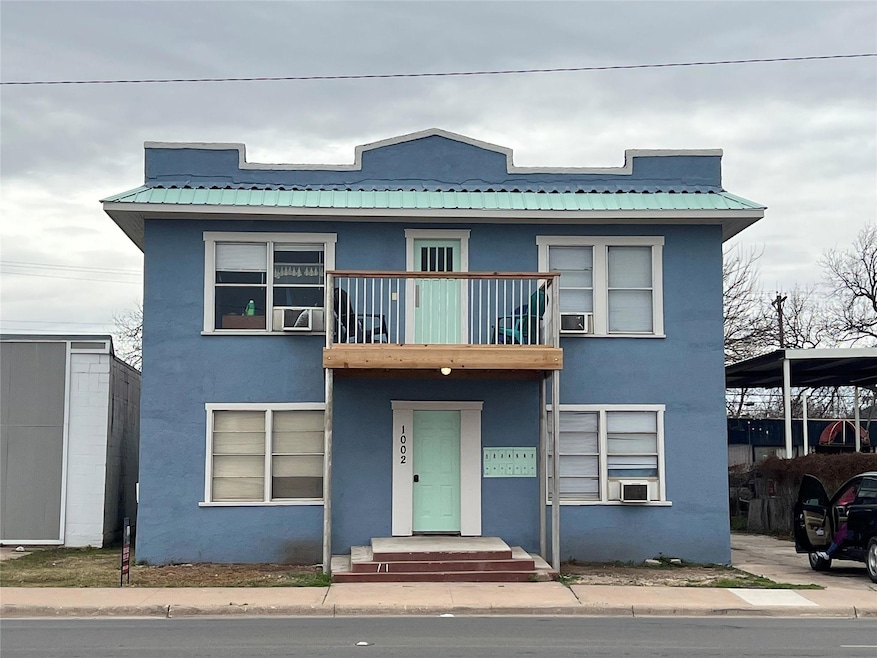 View of front of property featuring a balcony and 