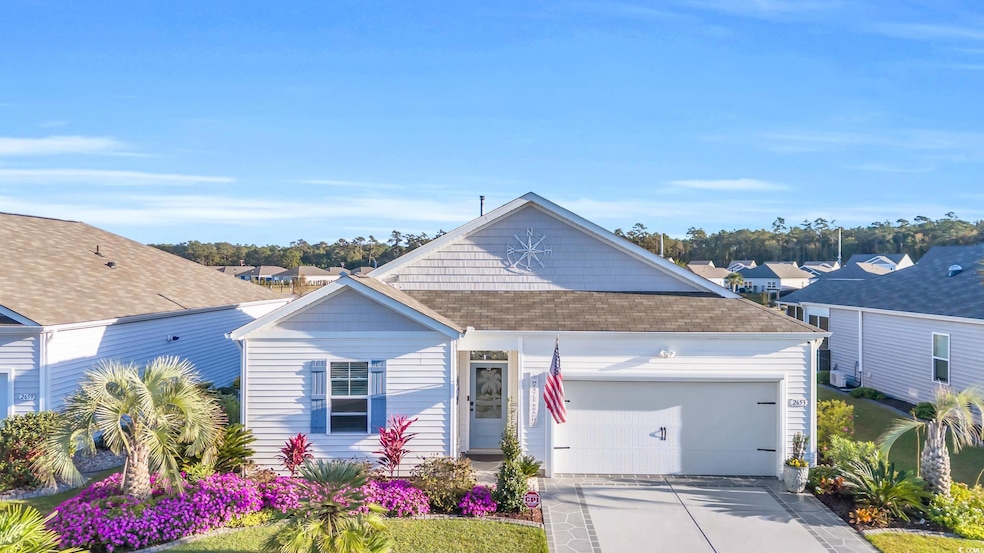View of front of property with an attached garage, roof with shingles, and concrete driveway