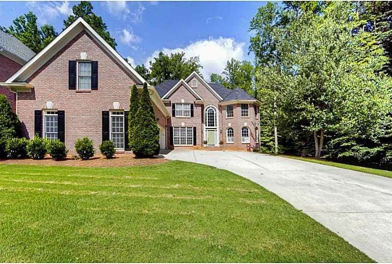 Exterior Front. 3 Sides Brick w/ 3 car garage on l