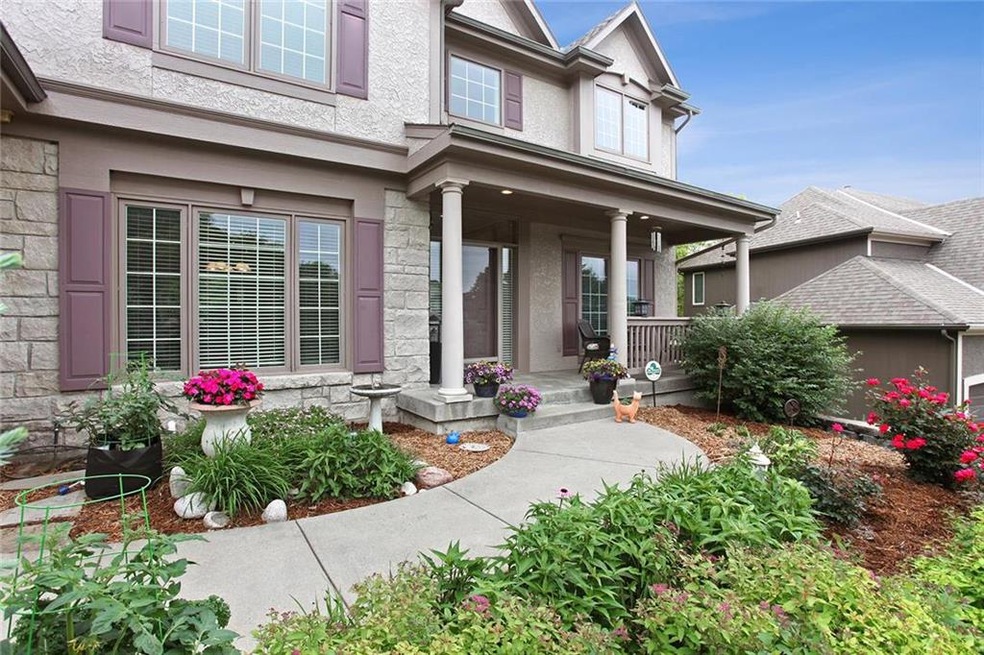 Come & sit & visit on this gorgeous front porch th