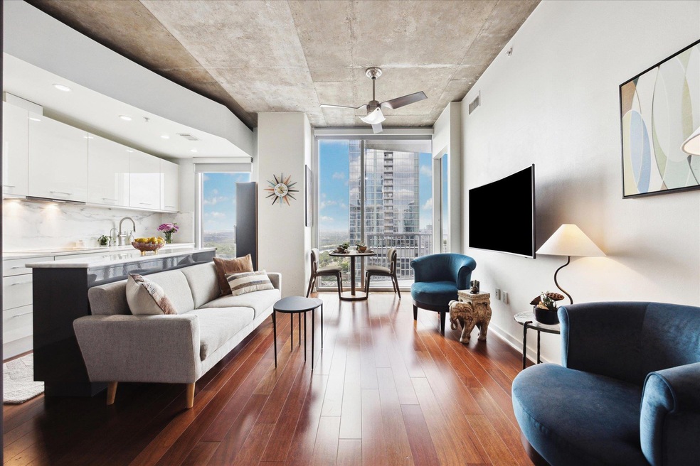 Living room with visible vents, ceiling fan, and 