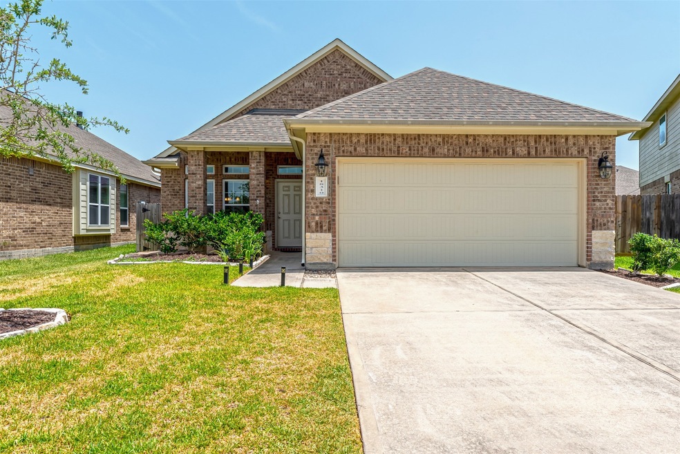 Welcome to your new home at 18310 Eli Cove Lane in the highly sought after neighborhood of Wildwood at Northpointe. From the minute you arrive, pride in ownership is displayed in this meticulously manicured yard and well-maintained brick and stone exterior.