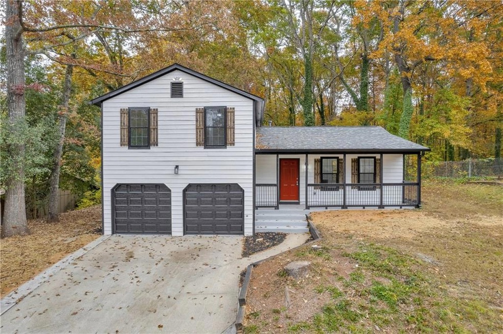 Split level home featuring a porch and a garage