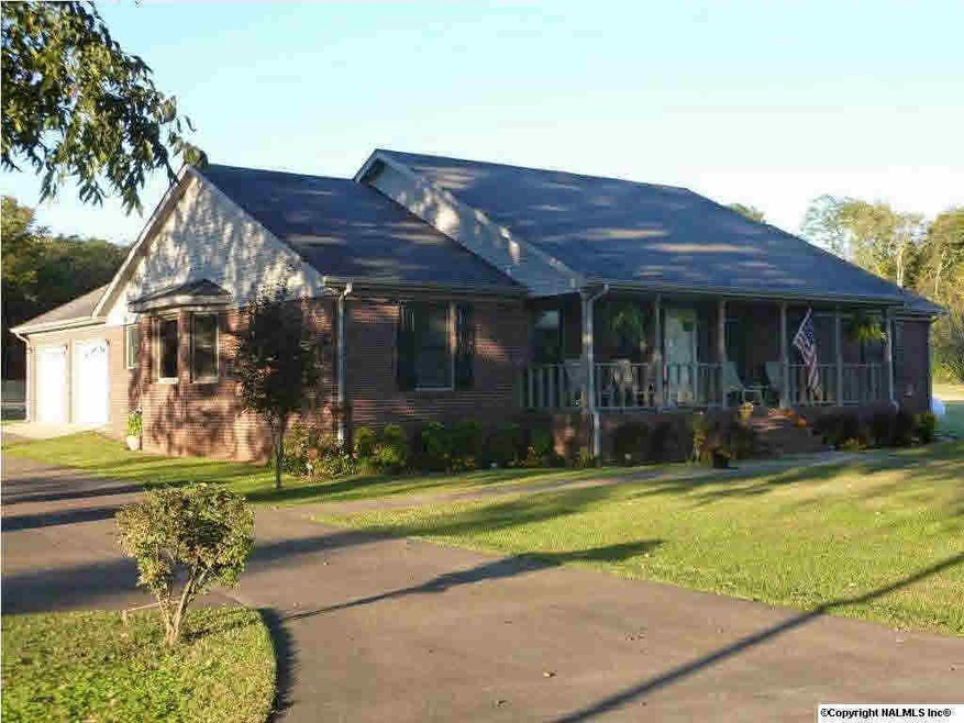 Front View of Home - Great curb appeal on this property with an inviting covered front porch, large shade trees, mature landscaping and a concrete drive.