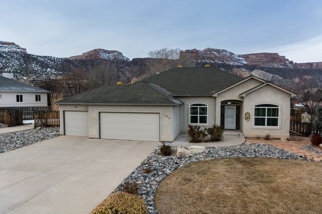 Main picture - front of home with 3 car garage and