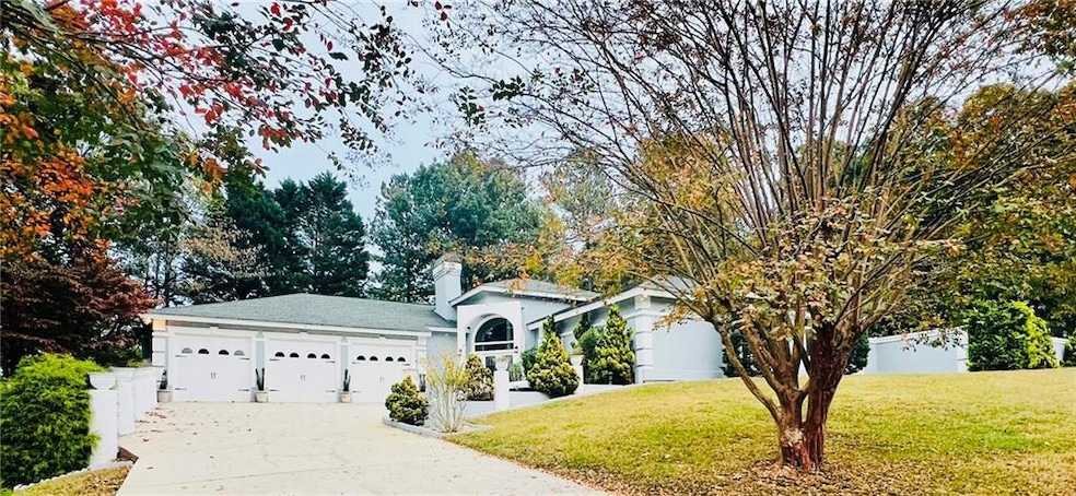 Ranch-style home featuring a front lawn and a gara