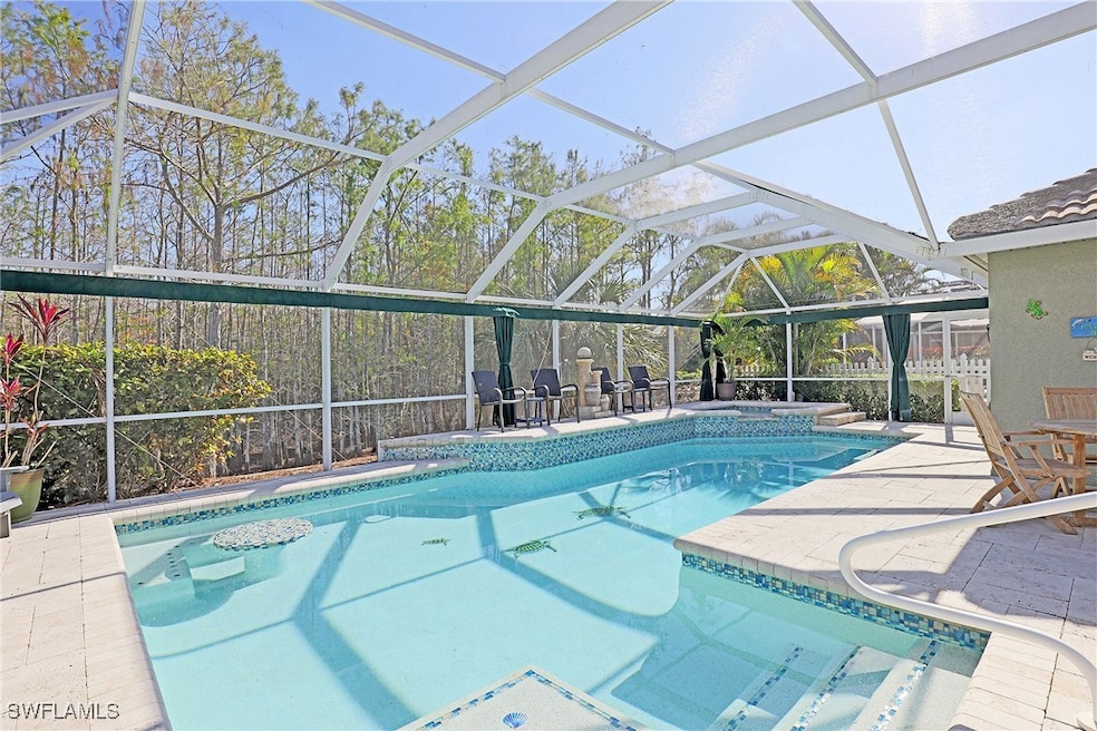 View of pool with a patio and glass enclosure