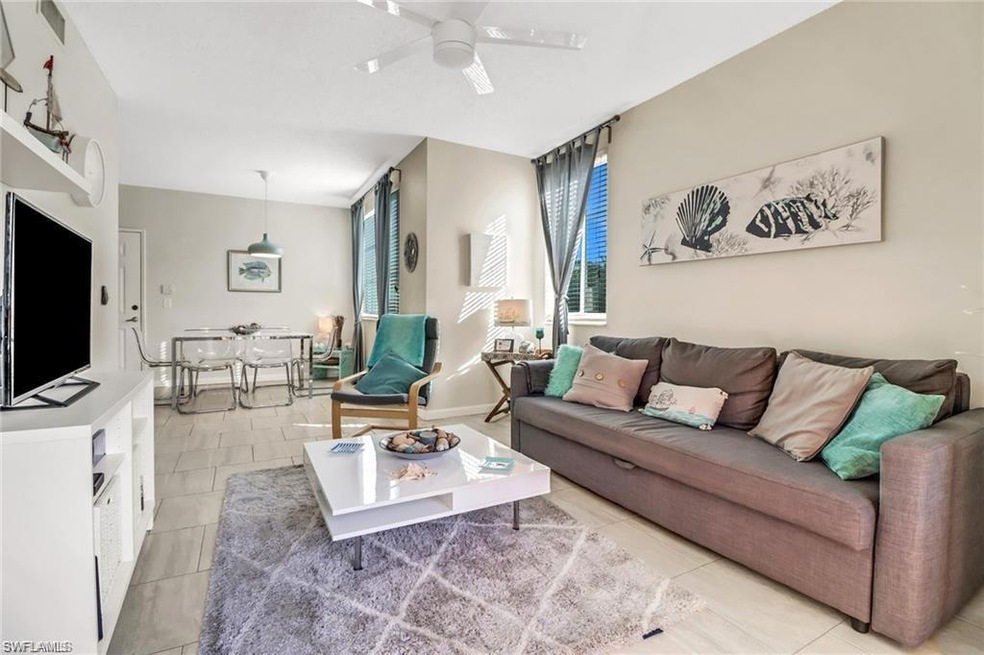 Living room with ceiling fan and light tile patterned floors