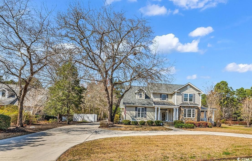 View of front of home featuring driveway, stone si