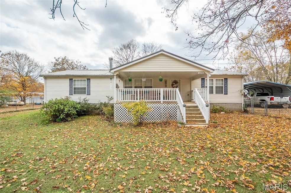 Bungalow featuring a porch and a carport