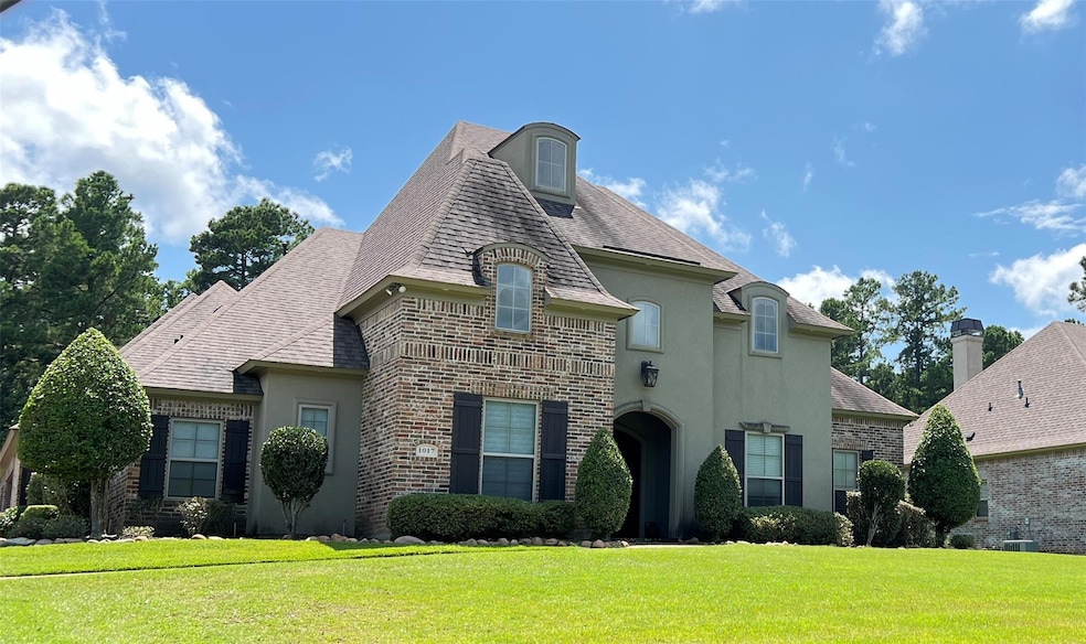 French country inspired facade with cooling unit a