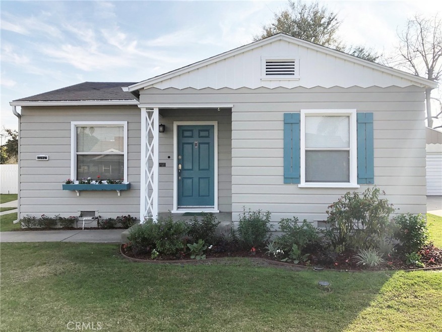 Expertly landscaped front yard with sprinklers