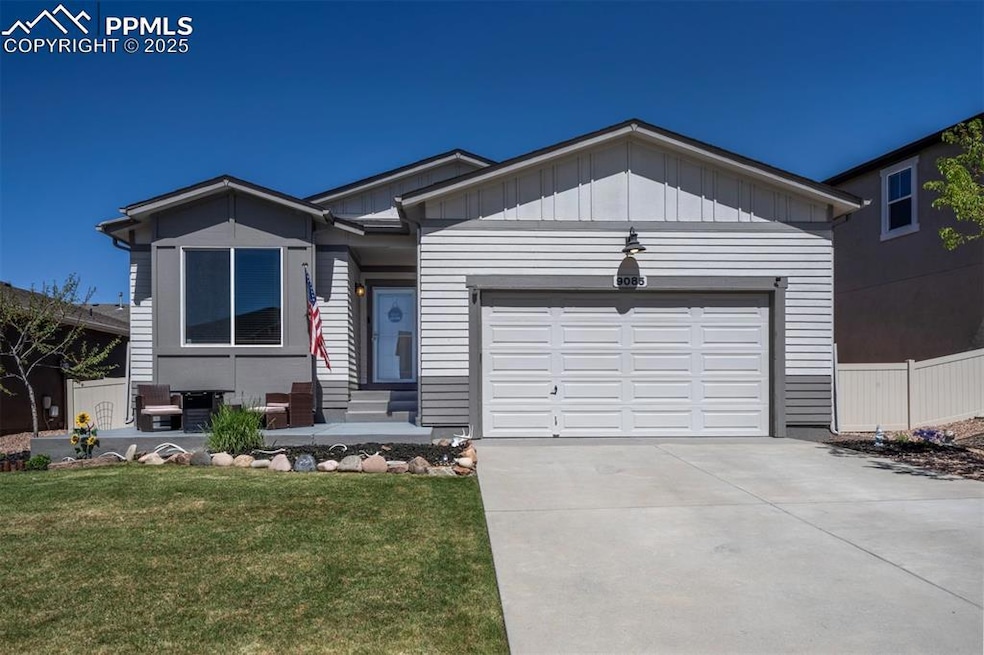 Single story home with driveway, a garage, and boa