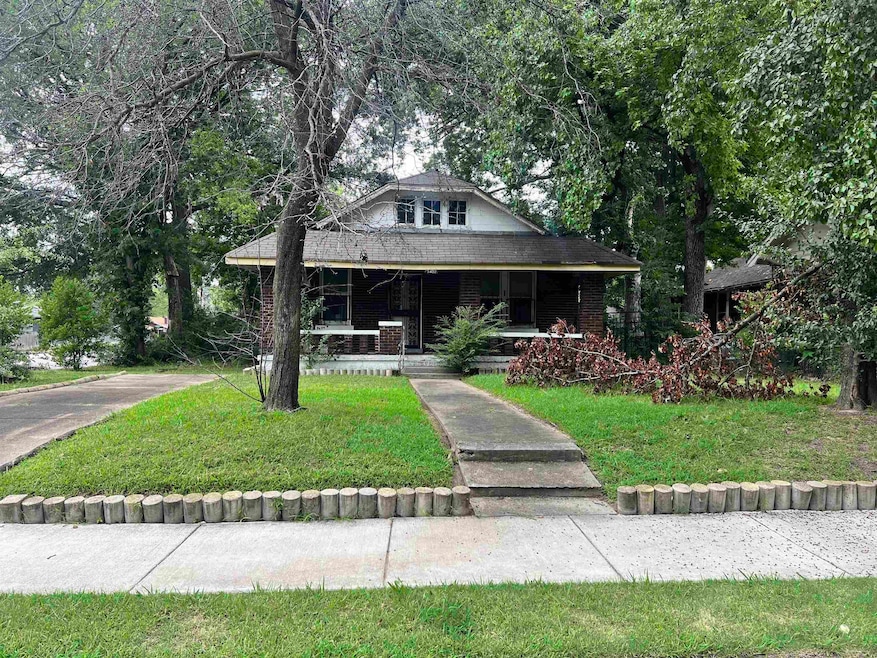View of front of house with a porch and a front la
