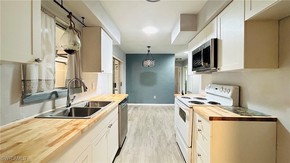 Kitchen with butcher block counters, pendant light