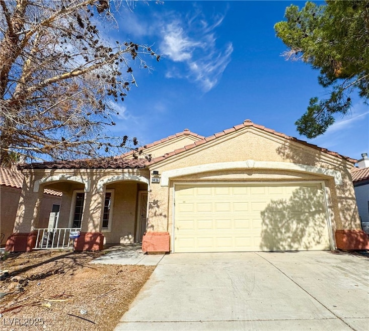 View of front of property with driveway, a garage,
