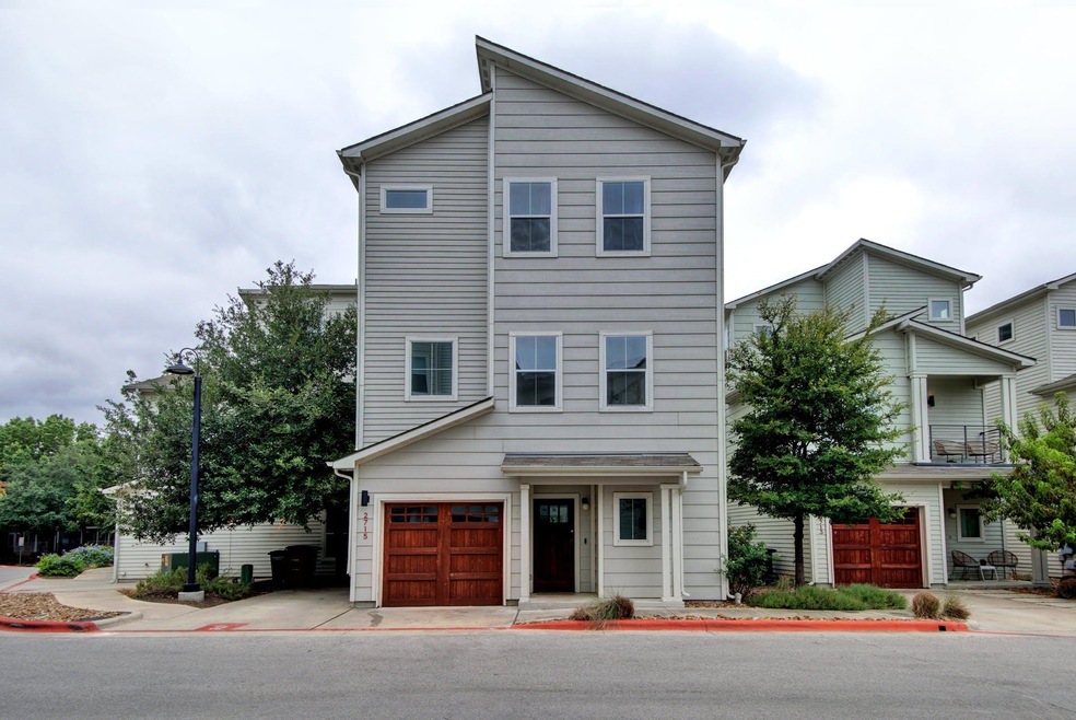 Modern home featuring an attached garage and conc