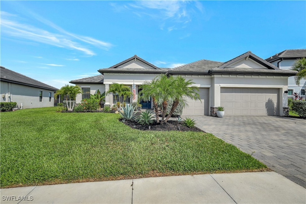 Ranch-style house with decorative driveway, a fron