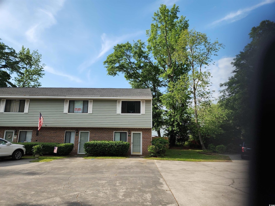 View of front of property with uncovered parking a