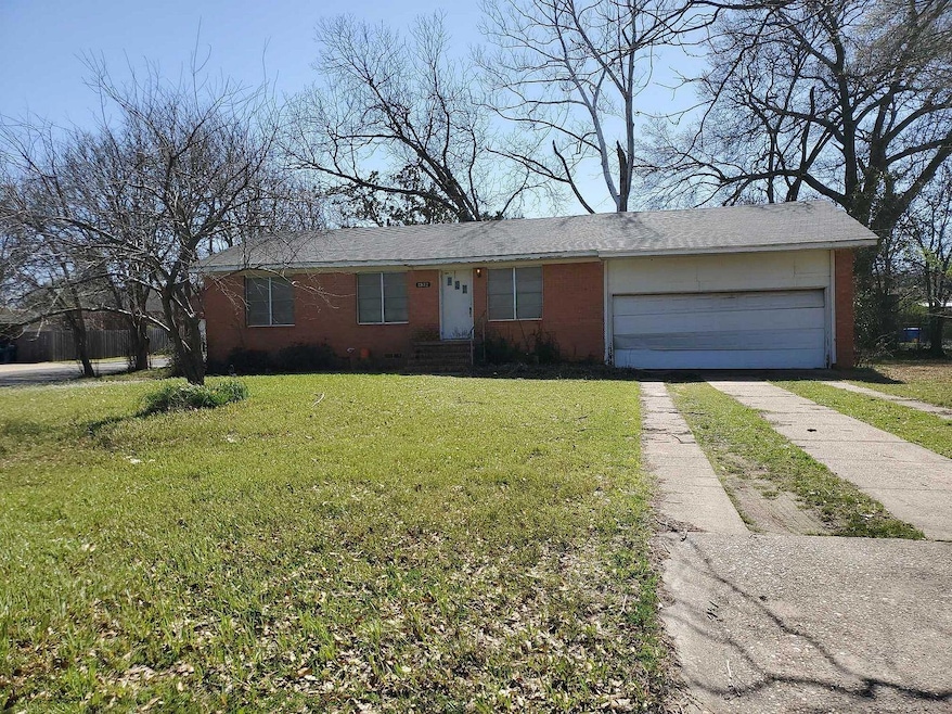 Single story home with brick siding, driveway, an 