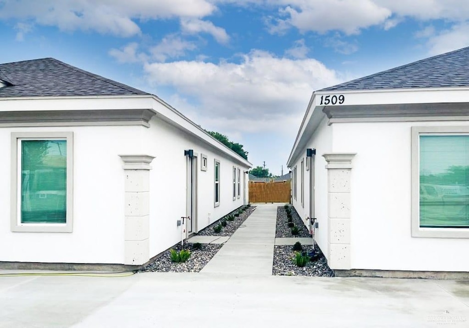 View of side of home featuring roof with shingles
