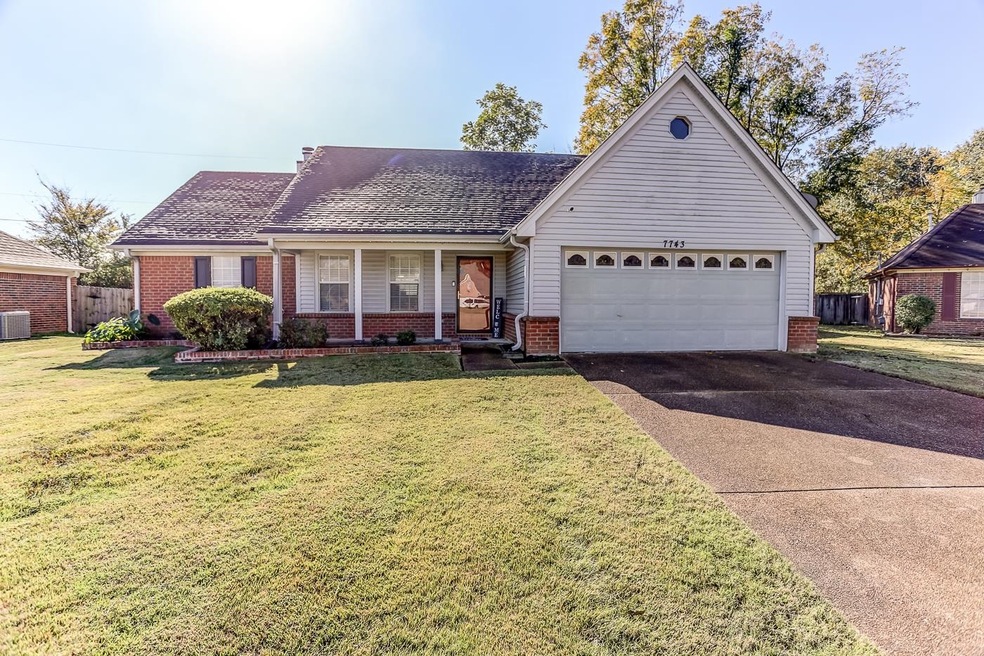 Ranch-style house with cooling unit, a garage, and