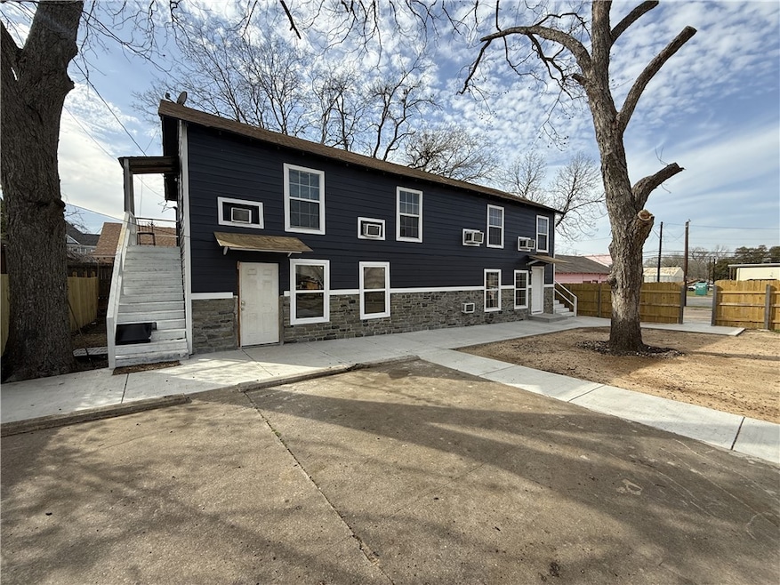 View of front of property with stairway, a patio a