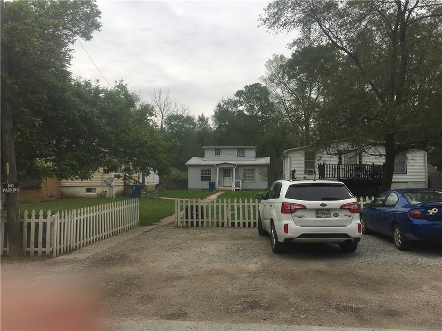 front showing all three homes and parking