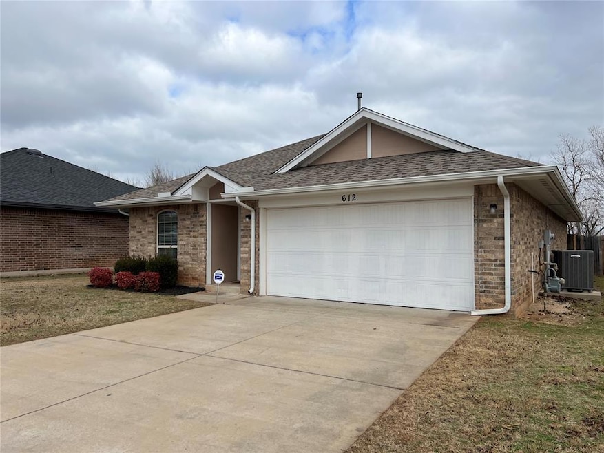 Ranch-style home with driveway, a garage, roof with shingles, central air condition unit, and brick siding