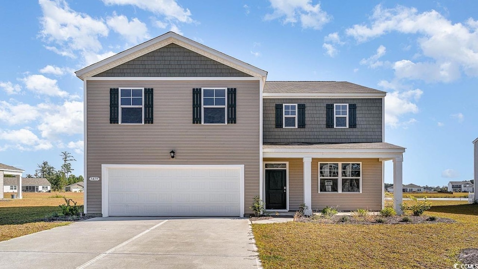 View of front of property with driveway, a garage,