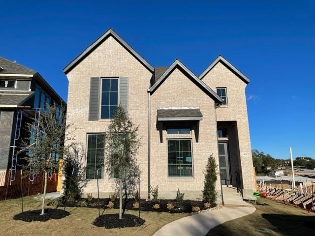 View of front of home featuring brick siding and 